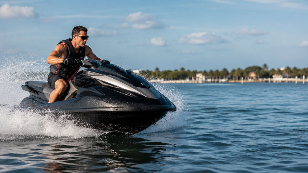Rider on a high-performance jet ski at full speed on open water — fastest jet skis guide
